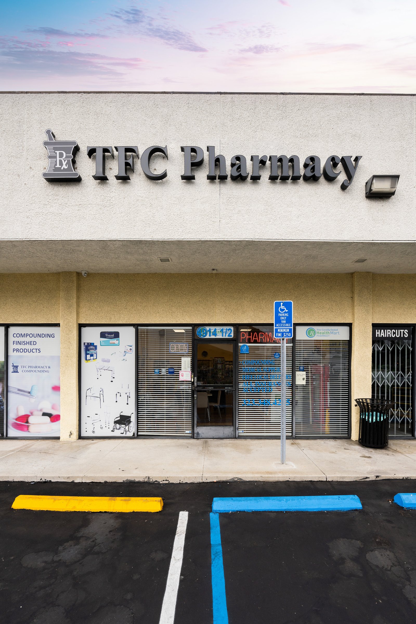 TFC Pharmacy storefront at dusk on Slauson Avenue